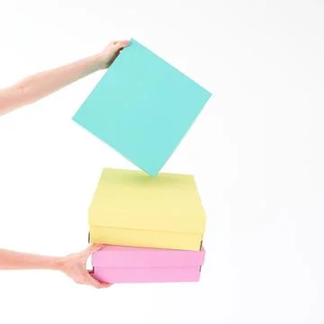 Colored boxes are held on a white background. There is space for text. The .. Stock Photos
