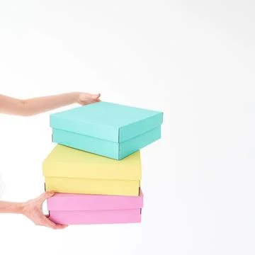 Colored boxes are held on a white background. There is space for text. The .. Stock Photos