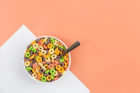 Colored breakfast cereal on a colored background, flat lay, copy space. Foto stock