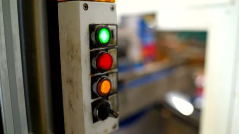 Colored buttons glows on a control panel of conveyor Stock Footage 148947338