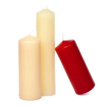 Colored candles of different size on white background Stock Photos