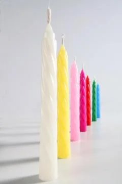 Colored candles on white background Stock Photos