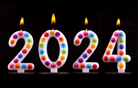 Colored candles write numbers flame Happy new year 2024 Stock Photos