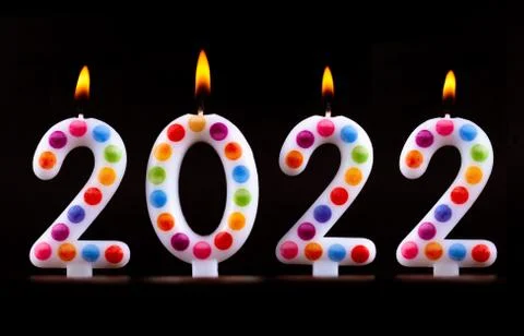 Colored candles write numbers flame Happy new year 2022 Stock Photos