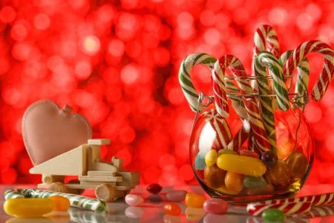 Colored candy on blurred bokeh background. Pink heart on a toy truck. A sweet Stock Photos