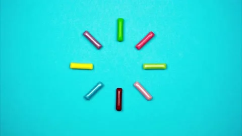 Colored candy sticks appear in circle and blink. Loading sign from candies Stock-Footage 168648507