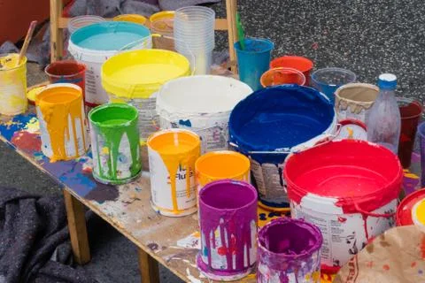 Colored cans open on a table Stock Photos
