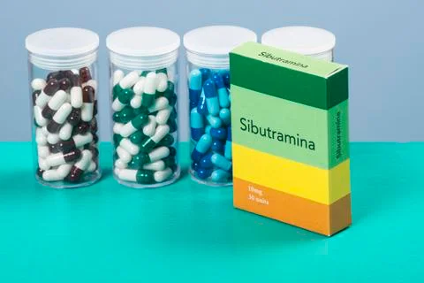 Colored capsule of medication in transparent plastic storage container Stock Photos