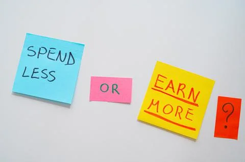 Colored cards with text "spend less or earn more". Stock Photos