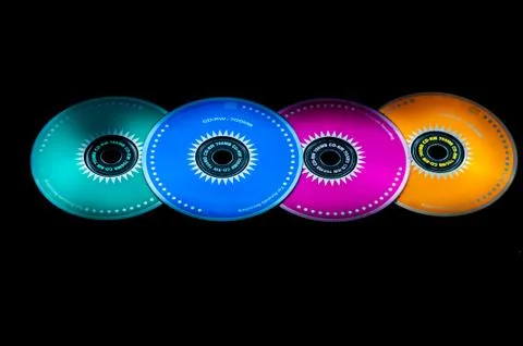 Colored cdrom on black background Stock Photos