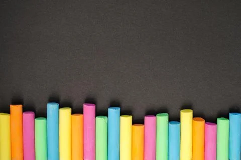Colored chalk on black background. Back to school. Space for your text Stock Photos