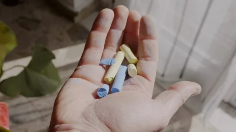 Colored chalks in the hand - Slow Motion Stock Footage 125046178