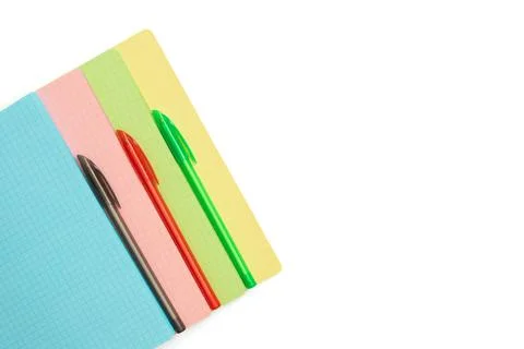 Colored checkered sheets and pens isolated on a white background. Stationery  Stockfoto's