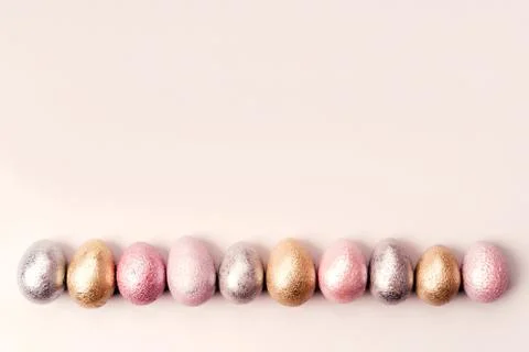 Colored chicken and quail eggs of pink, silver, golden, purple color Photos