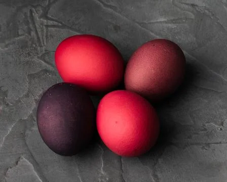 Colored chicken eggs on a dark background. Easter eggs. Place for an inscription Stock Photos