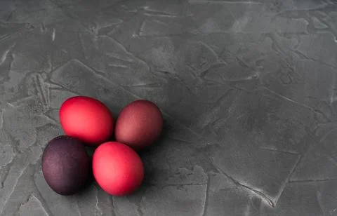 Colored chicken eggs on a dark background. Easter eggs. Place for an inscription Stock Photos