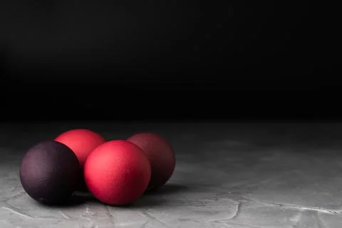Colored chicken eggs on a dark background. Easter eggs. Place for an inscription Stock Photos