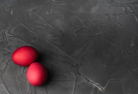 Colored chicken eggs on a dark background. Easter eggs. Place for an inscription Stock Photos