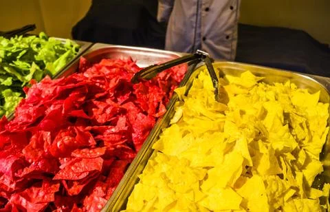Colored chips. sale of chips. Multi-colored snacks. Concept unhealthy food. Stock Photos