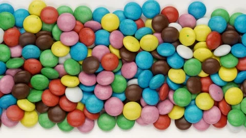 Colored chocolate dragees. Sweets, dolly shot. Video stock 153138977