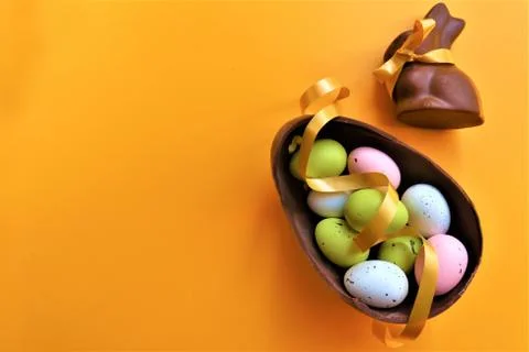 Colored chocolate Easter eggs and chocolate bunny Stock Photos
