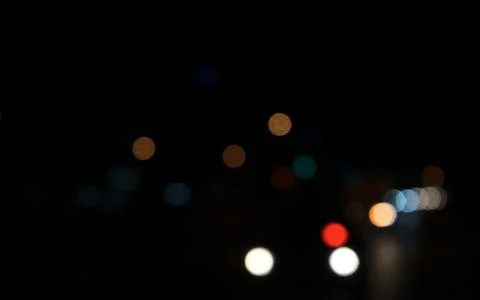 Colored circles bokeh of car lights at black dark night in city. Blurry abs.. 스톡 사진