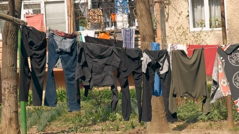 Colored clothes drying on the balcony of an old house in Italian city. 4k. Slow Stockbeeldmateriaal 128216121
