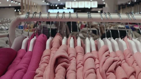 Colored clothes on a hanger in a store. Stock Footage 219577787