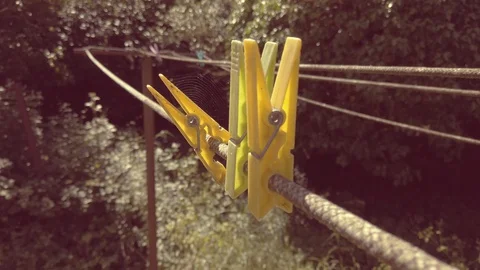 Colored clothes pegs outside in a sunny day Stock Footage 129654070