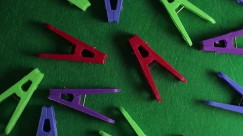 Colored clothespins on a green textured background, top view, close-up, brigh Stock Footage 195517128