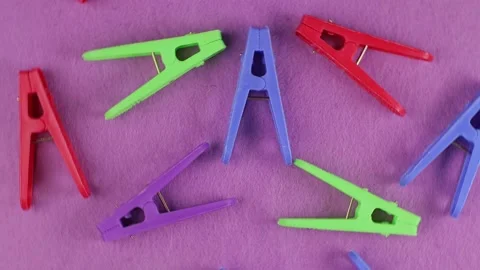 Colored clothespins on a lilac background, top view, close-up, bright backdro Stock Footage 171660019