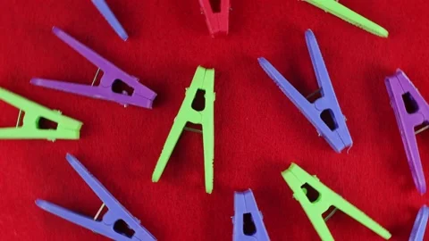 Colored clothespins on a red textured background; top view; close-up; bright  Stock Footage 172361668