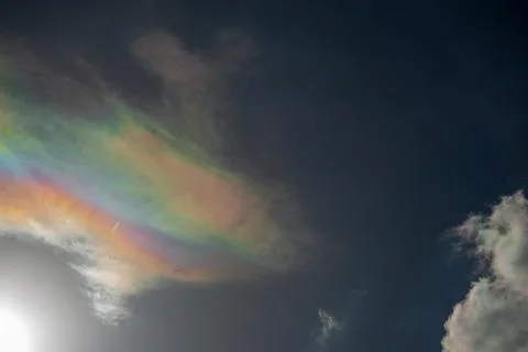A colored cloud in a blue sky Stock Photos