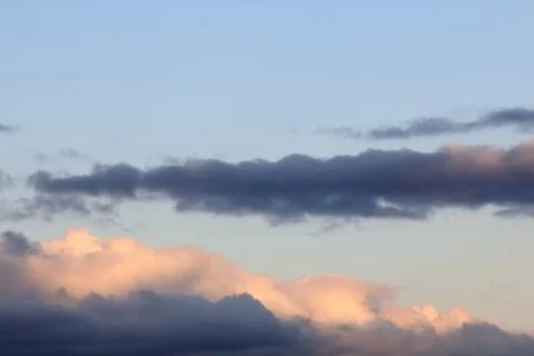 Colored clouds on the blue sky Stock Photos
