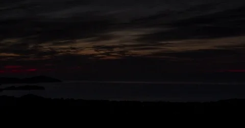 Colored clouds float above the blue mountains at evening Stock Footage 75612258