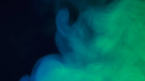 Colored clouds of smoke are slowly flowing on black background. Stock Footage 127900830
