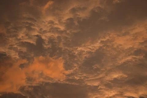 Colored Clouds at Sunset near the Ocean Stock Photos