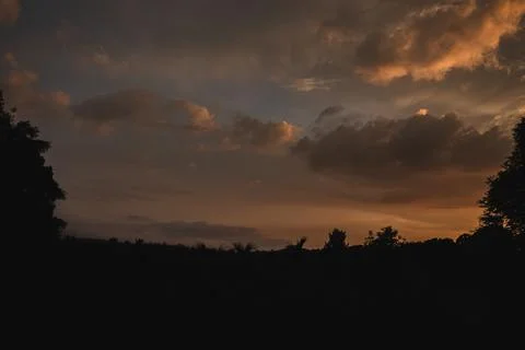 Colored Clouds at Sunset near the River Stock Photos