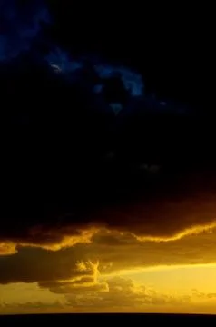 Colored clouds at sunset Stock Photos