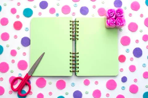 Colored confetti on white background notepad flat lay top view. Stock Photos
