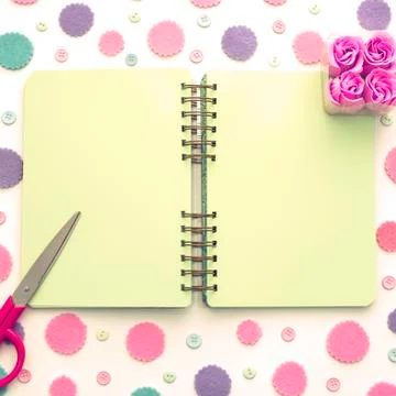Colored confetti on white background notepad flat lay top view. Stock Photos