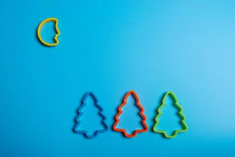 Colored cookie cutters for the preparation of a three Christmas tree and the  Stock Photos