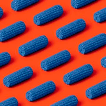 Colored corn cobs on red Stock Photos