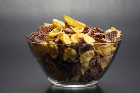 Colored corn flakes in a bowl. raw flour food. Stock Photos