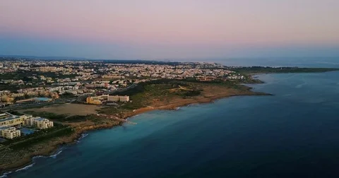Colored cozy town at sunset over the island. Video shooted with drone. Stock Footage 76662592