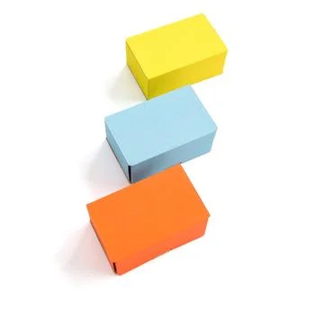 Colored craft boxes on a white background. Orange, blue, yellow. Place for .. Stock Photos