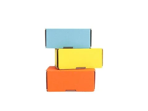 Colored craft boxes on a white background. Orange, blue, yellow. Place for .. Stock Photos