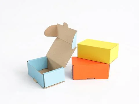 Colored craft boxes on a white background. Orange, blue, yellow. Place for .. Stock Photos