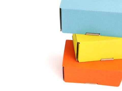 Colored craft boxes on a white background. Orange, blue, yellow. Place for .. Stock Photos