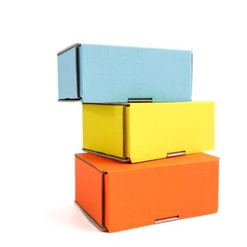 Colored craft boxes on a white background. Orange, blue, yellow. Place for .. Stock Photos